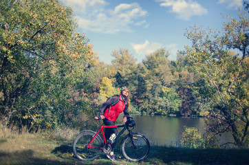 girl with a bicycle among the trees