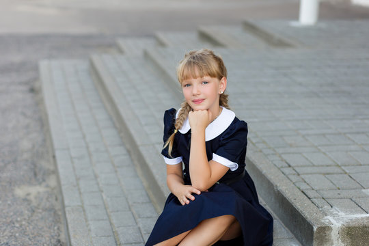 Portrait of a beautiful girl in a school uniform before class at school