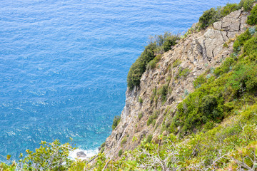 View from mountains to coastline and blue sea. Riomaggiore, Italy