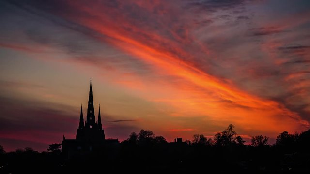 Timelapse heavenly clouds at sunset over Lichfield City Cathedral Midlands silhouette, England November 2017