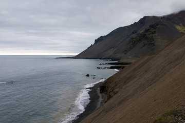 Iceland - landscape - ocean, fjord, hills and mist and clouds. Selective focus.