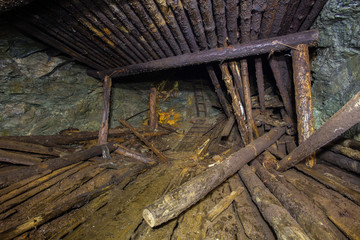 Collapsed timbering in the abandoned ore mine shaft tunnel