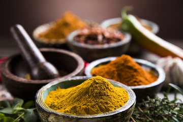Assortment of spices in wooden bowl background 