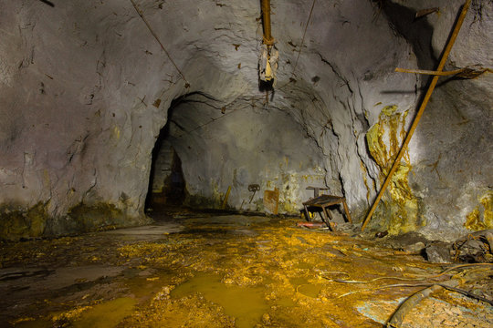 Underground copper ore mine shaft tunnel gallery with yellow dirt