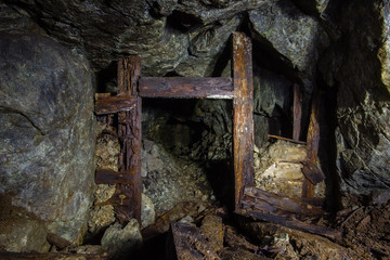 Underground mine shaft copper ore tunnel gallery with wooden stands timbering