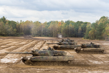 german main battle tanks drives on battlefield © Katja