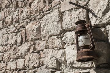  rusty gas lamp with stone wall hanging