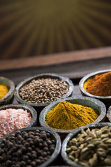 Assortment of spices in wooden bowl background 