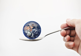 Blue planet earth on spoon, isolated on white background. Elements of this image is furnished by...