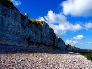 Chalk cliffs and stony coastline in Normandy, France.