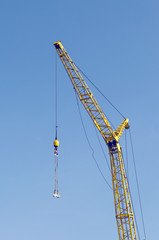 Naklejka premium Construction crane against the blue sky