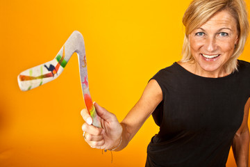 woman posing with a boomerang - obrazy, fototapety, plakaty