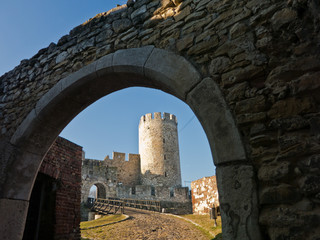 Fototapeta premium Wooden bridge and gate at the entrance of Kalemegdan fortress on a sunny autumn day in Belgrade, Serbia