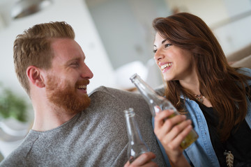 Young beautiful couple flirting and smiling at home