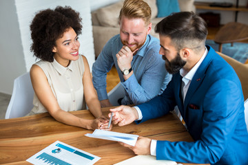 Young couple talking to estate agent