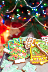 Homemade christmas tree shape gingerbread cookies on illuminated  festive background