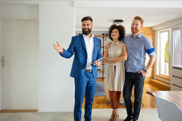 Young couple looking new home with agent