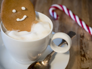 gingerbread man bathing in a cup of coffee