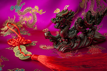 Wealth and power symbolized by the fengshui coins charm and the asian mystic dragon. Feng Shui is a Chinese philosophical system of harmonizing everyone with the surrounding environment