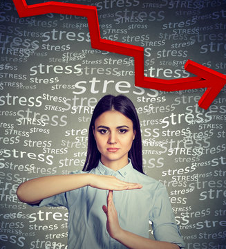 Young woman with time out hand gesture requesting to decrease stress level