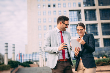 Business people discussing ideas at meeting outside