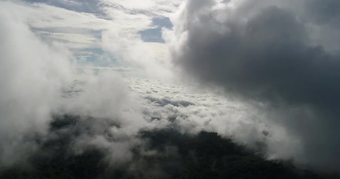 Aerial View. Flying over the beautiful mountain in clouds.