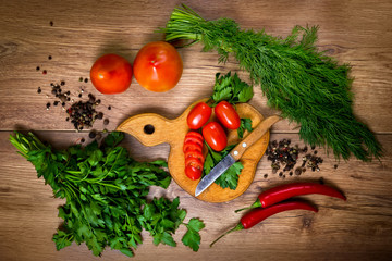 Sliced cherry tomatoes, vegetables and seasonings, parsley, dill, garlic. preparation for cooking