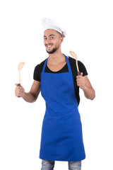 Happy smiling chef, holding two wooden spoons. isolated on white background