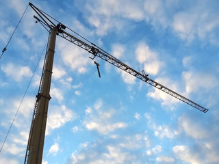 construction crane against blue and white sky