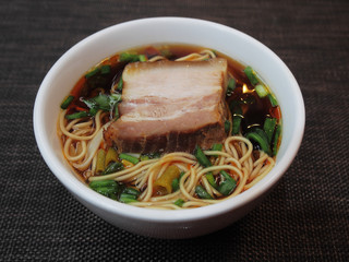 Bowl of noodles with pork slices   