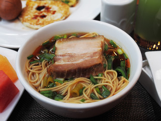 Bowl of noodles with pork slices   