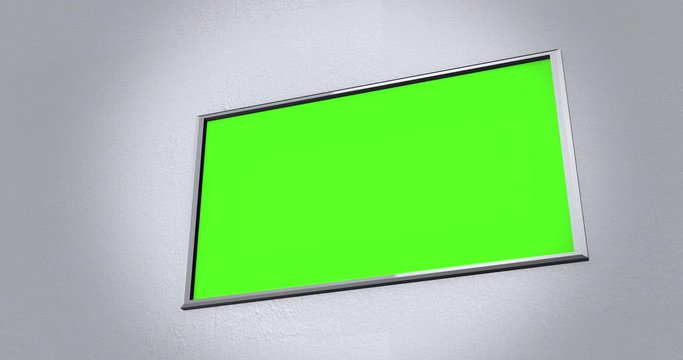 Camera pans across modern flatscreen 4K UHD TV on wall ALT