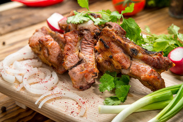 Assorted delicious grilled meat with vegetable on white plate  picnic table for family bbq party