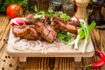 Assorted delicious grilled meat with vegetable on white plate  picnic table for family bbq party