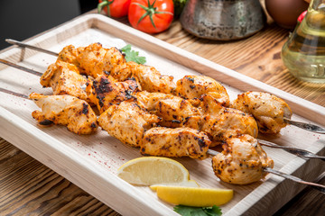 Assorted delicious grilled meat with vegetable on white plate  picnic table for family bbq party