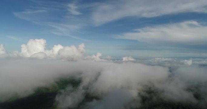Aerial View. Flying over the beautiful mountain in clouds.