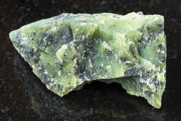 rough Lizardite stone on dark background