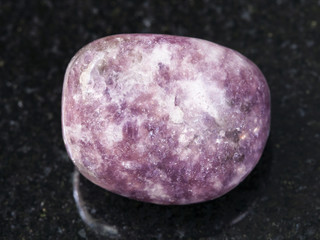 tumbled Lepidolite gemstone on dark background