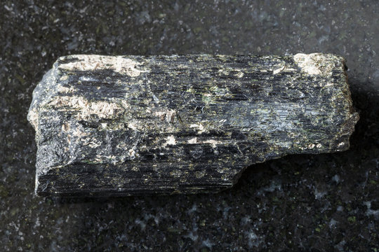 raw aegirine crystals on dark background