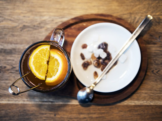 Tea in a transparent cup with orange slices, white and brown sugar refined sugar