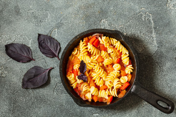Vegetarian fusilli pasta with salsa sauce top view with copy space