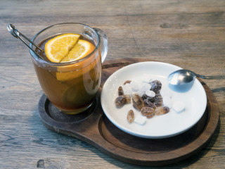 Tea in a transparent cup with orange slices, white and brown sugar refined sugar