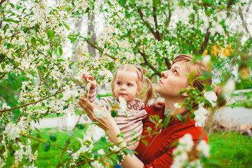 mother and daughter in flower garden