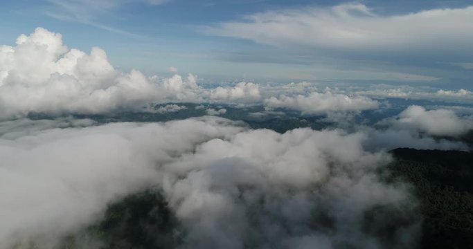 Aerial View. Flying over the beautiful mountain in clouds.