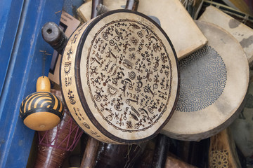 Fototapeta na wymiar Drums (bendir) for sale outside Music shop in Essaouira's Medina in Morocco