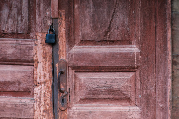 old wooden door with metal handle and lock