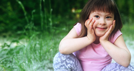 Portrait of beautiful little girl with down syndrome