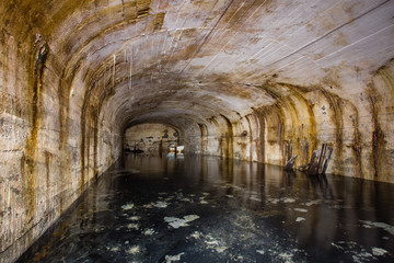 Underground mine shaft iron ore tunnel gallery with flooded water