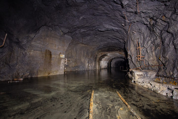 Underground mine shaft iron ore tunnel gallery with flooded water