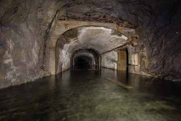 Underground mine shaft iron ore tunnel gallery with flooded water